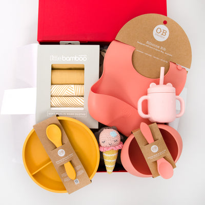 We love this collection of meal time essentials for L plate eaters.  Included is a silicone bib, plate, bowl with spoons and adorable bear sippi cup in pretty sunset tones.  This hamper also includes a pack of soft muslin washers for cleaning up little hands and a cute Ice Cream Rattle to help keep bub amused whilst waiting for lunch. All items are beautifully presented in our chic, red, signature memory box. $169.00