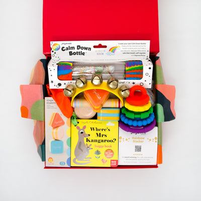 This thoughtful hamper features a selection of toys to stimulate little ones coordination, motor strength and senses.  Included is a calmdown bottle,stack toy, shape shakers, peeek-a-boo board book and bell rattle. $120.00